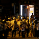 Men in white T-shirts and carrying poles are seen in Yuen Long after attacking anti-extradition bill demonstrators at a train station in Hong Kong, China, July 22, 2019.